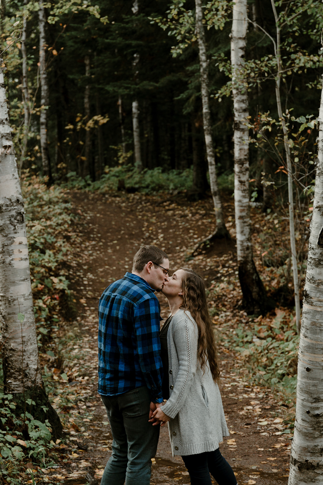 Couple kissing on hiking trail in the fall